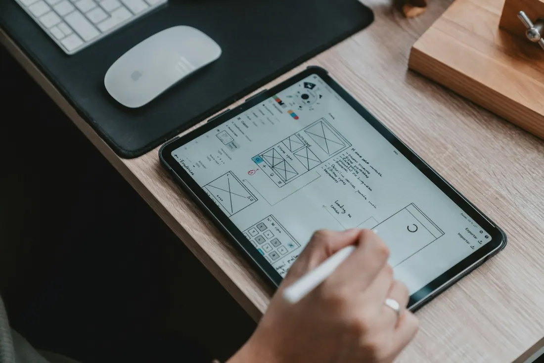 Designer drawing wireframes on a tablet